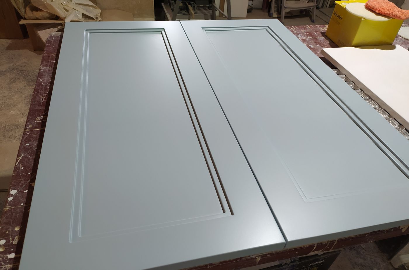 Sage green panel doors with a matte Renner finish